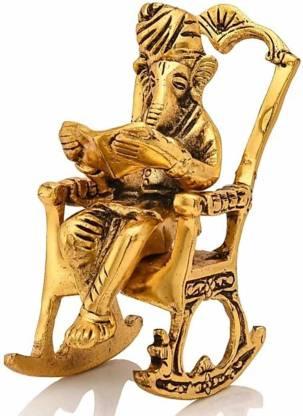 HomeSutra Golden Lord Ganesha Statue Sitting On A Rocking Chair And Reading Ramayan Showpiece