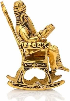 HomeSutra Golden Lord Ganesha Statue Sitting On A Rocking Chair And Reading Ramayan Showpiece